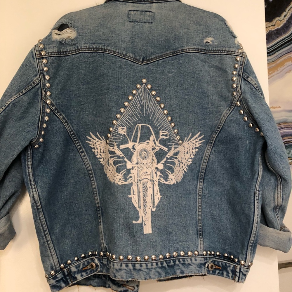 Studded and embroidered oversized denim jacket.